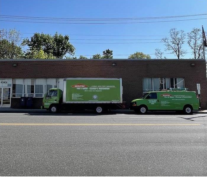 SERVPRO van and box truck parked on the street